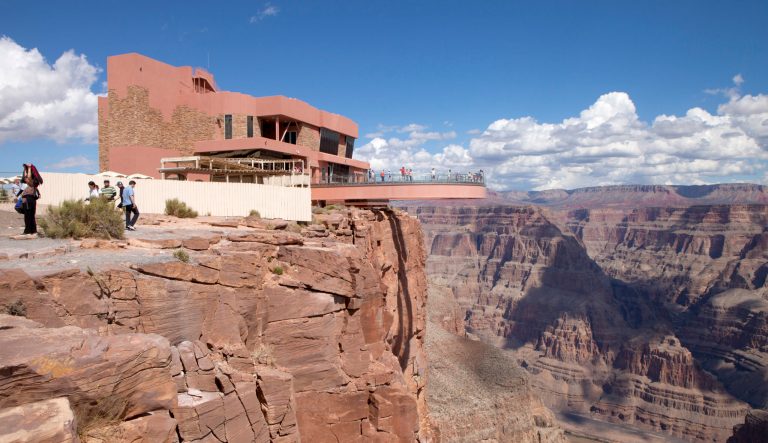 Tourist enjoying the view of the west rim of The Grand Canyon from the Skywalk.