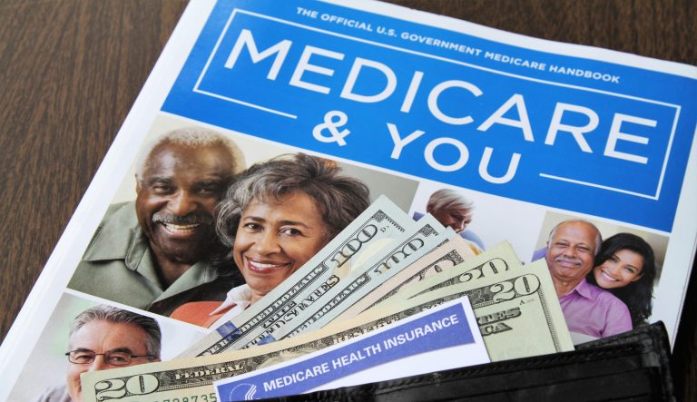 Medicare and Social Security cards with USA currency cash.  