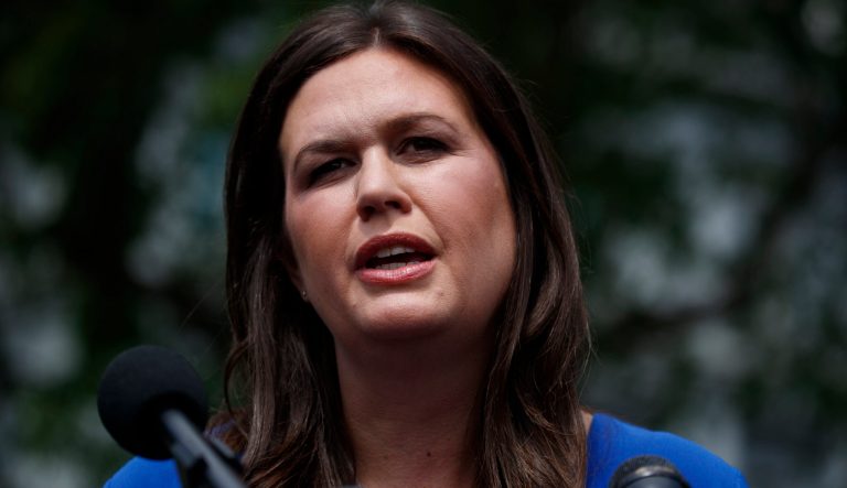 White House press secretary Sarah Sanders speaks with reporters outside the White House