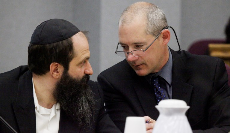 Defense attorney Montgomery Brown, right, and defendant Sholom Rubashkin talk during the trial on state child labor charges.