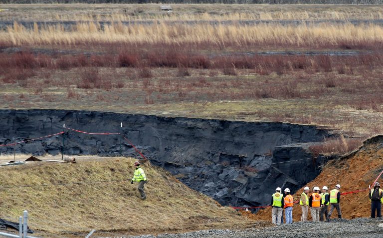Duke Energy engineers and contractors survey the site of a coal ash spill at the Dan River Power Plant in Eden, N.C., on Feb. 5. (AP Photo/Gerry Broome, File)