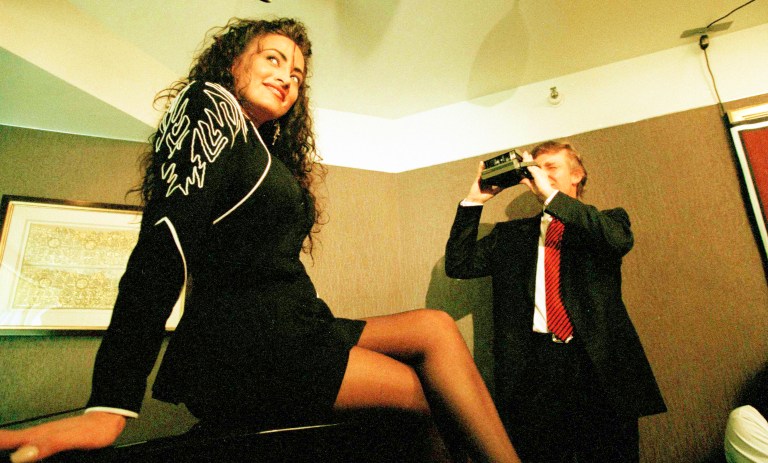 Donald Trump using an instant camera to make a picture of Playmate hopeful Lisa Madison during a publicity session in New York, May 3, 1993. (AP Photo/Mike Albans)