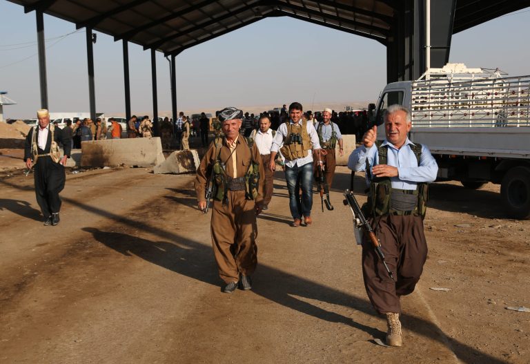 Kurdish Peshmerga fighters walk toward the front line with militants from the extremist Islamic State group, at the Khazer checkpoint outside of the city of Irbil in northern Iraq, Friday, Aug. 8, 2014. Iraqi Air Force has been carrying out strikes against the militants, and for the first time on Friday, U.S. war planes have directly targeted the extremist Islamic State group, which controls large areas of Syria and Iraq. (AP Photo/Khalid Mohammed)