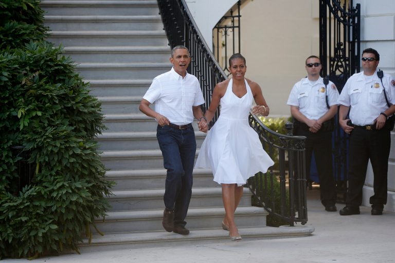 President Barack Obama and first lady Michelle Obama walk from the South Portico to greet military families as they host an Independence Day celebration on the South Lawn at the White House in Washington, Friday, July 4, 2014. (AP Photo/Charles Dharapak)