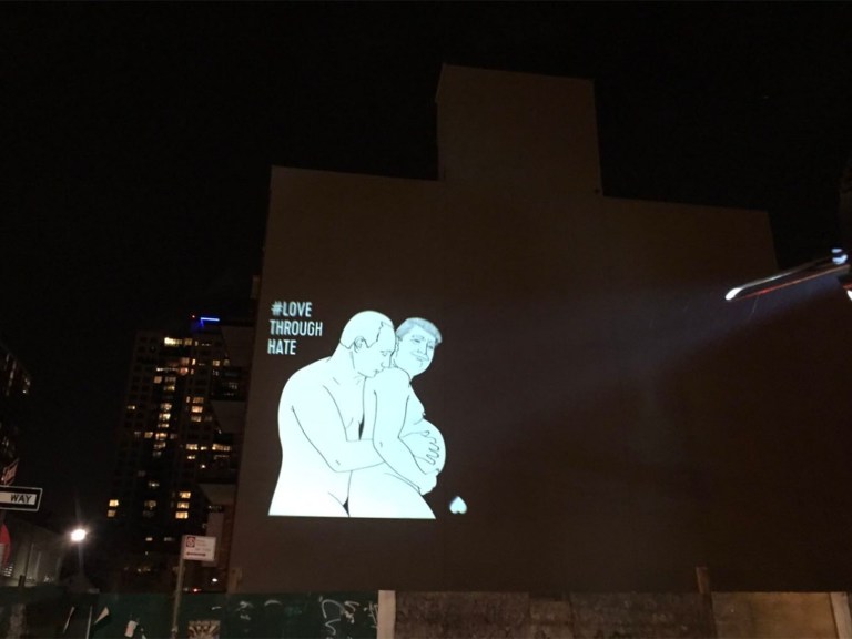 An image of President Trump being caressed by Putin appeared on a New York City building on Valentine's Day. (Screengrab/Twitter @katz)