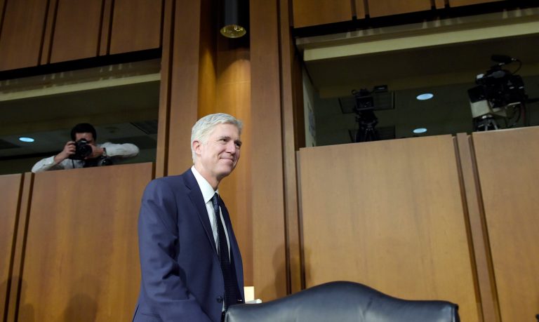 Supreme Court Justice nominee Neil Gorsuch walks out of the hearing room on Capitol Hill in Washington on March 22 during a break in his confirmation hearing before the Senate Judiciary Committee. (AP Photo/Susan Walsh)