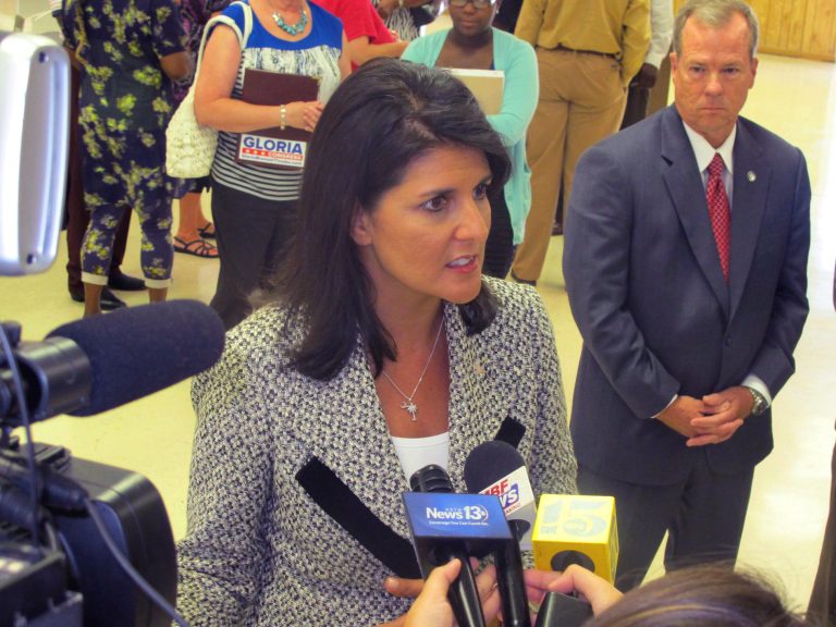 FILE - In a July 29, 2014 file photo, South Carolina Gov. Nikki Haley listens to a question while meeting with reporters in Atlantic Beach, S.C. The governor has called on the town to end the Atlantic Beach Bikefest following violence in the Myrtle Beach area last Memorial Day. To Haley's left is Duane Parrish, the director of the South Carolina Department of Parks, Recreation and Tourism. Parrish said on Monday, Aug. 4, 2014 that Atlantic Beach would be eligible for both advertising and building money for an event to replace the Bikefest. He also said publicity about the violence likely has hurt tourism this summer in the Myrtle Beach area. (AP Photo/Bruce Smith, File)