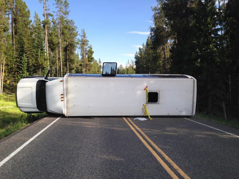 This Thursday, July 10, 2014 photo provided by the Grand Teton National Park shows a bus that flipped on its side in Grand Teton National Park. Officials say about two dozen people were taken to a hospital after a bus flipped on its side. Authorities say no other vehicles were involved. It wasn't clear who owned the bus or whether it was on a tour. (AP Photo/Michael Nash, Grand Teton National Park)