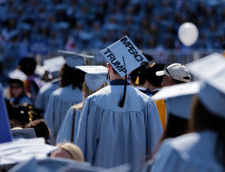 A student wears a hat reading 