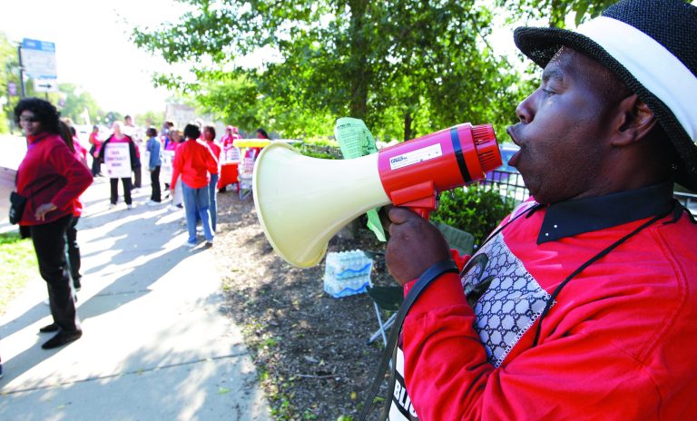 Michael Grant, a parent of a Chicago public school student, walks a picket line outside Shoop Elementary School in support of striking CPS teachers, Tuesday, Sept. 11, 2012. This is the second day of a strike in the nation's third-largest school district as negotiations by the two sides failed to reach an agreement Monday in a bitter contract dispute over evaluations and job security. (AP Photo/M. Spencer Green)