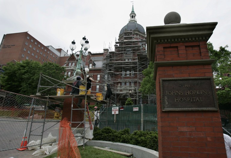 FILE - In this May 19, 2005 file photo, construction workers work on part of the Johns Hopkins Hospital in Baltimore. A union for more than 2,000 people who clean the hospital is negotiating for a new contract. The union has already held one short strike, although a four-day walkout was avoided in late June 2014 when both sides heeded Democratic Gov. Martin O'Malley's call for a one-week cooling off period. That's led the parties back to the bargaining table. (AP Photo/Chris Gardner, File)
