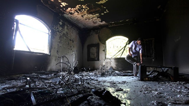 A Libyan man investigates the inside of the U.S. Consulate in that country after an attack that killed four Americans, including Ambassador Chris Stevens, in September of this year. (Mohammad Hannon/AP Photo)