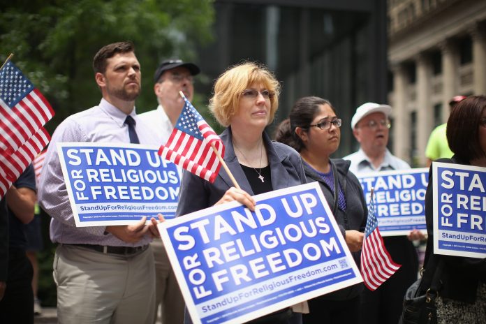 Religious freedom supporters hold a rally to praise the Supreme Court's 5-4 decision in the Hobby Lobby case, June 30, 2014 in Chicago, Illinois. Â (Photo by Scott Olson/Getty Images)