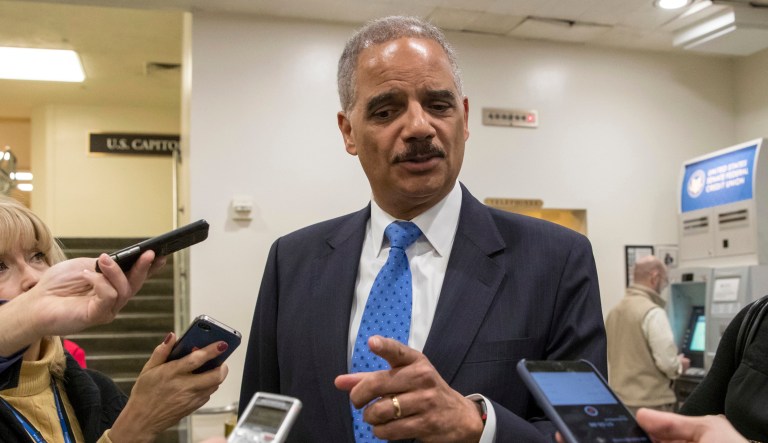 Former Attorney General Eric Holder takes questions from reporters at the Capitol where he attended the swearing-in of Sen. Doug Jones, D-Ala., in Washington, Wednesday, Jan. 3, 2018. Holder says he is "deeply disturbed" that Attorney General Jeff Sessions hasn't spoken out to defend his employees at the Justice Department amid Republican criticism of the FBI.