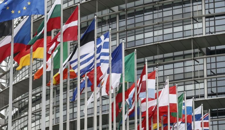 European flags in front of a building.