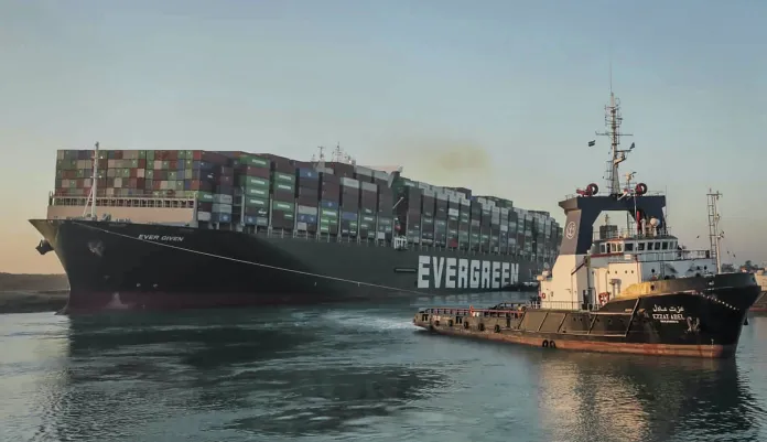 In this photo released by Suez Canal Authority, the Ever Given, a Panama-flagged cargo ship, is pulled by one of the Suez Canal tugboats, in the Suez Canal, Egypt, Monday, March 29, 2021. Engineers on Monday "partially refloated " the colossal container ship that continues to block traffic through the Suez Canal, authorities said, without providing further details about when the vessel would be set free. 