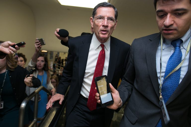 Sen. John Barrasso, R-Wyo., takes questions from reporters as he walks through the Senate subway on Capitol Hill, Thursday, June 29, 2017.