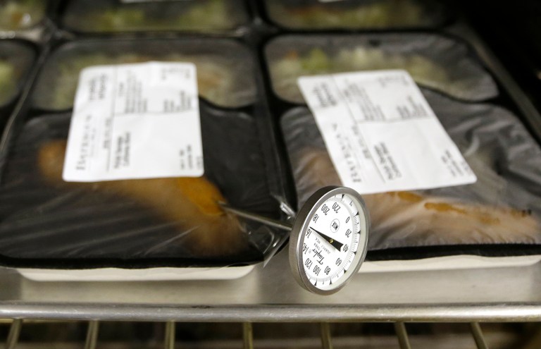 In this Thursday, May 7, 2015 photo, a thermometer is used to check the temperature of pre-made meals for delivery through the Meals On Wheels by ACC program at the Rush Park Community Center in Citrus Heights, Calif. The program provides free meals to senior citizens at the center and brings them meals at their homes. Meals on Wheels is among the programs that have received funds from the state Assembly's own administrative budget for programs that faced cuts in state and other funding. (AP Photo/Rich Pedroncelli)