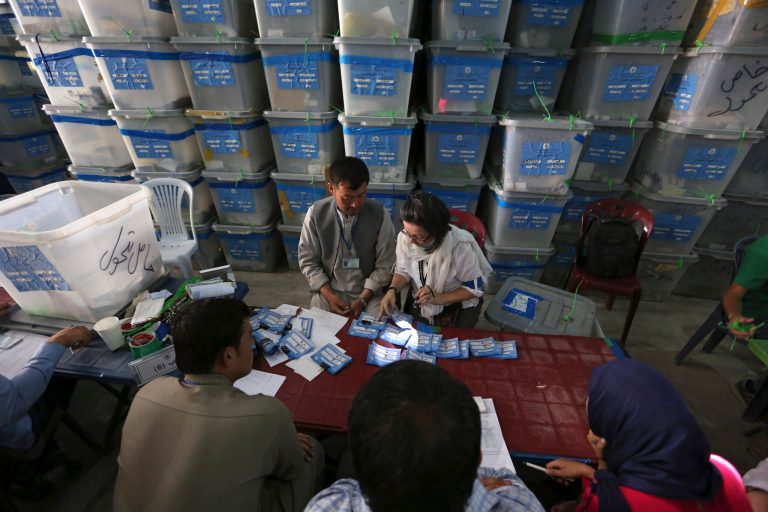 Afghan election commission workers sort ballots for an audit of the presidential run-off votes at an election commission office in Kabul, Afghanistan, Monday, Aug. 25, 2014. Afghanistan's president Hamid Karzai said in a statement that the inauguration ceremony for the next country's president will be held on September 2, 2014 and it is not subject to change. (AP Photo/Rahmat Gul