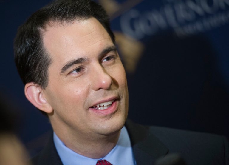 Wisconsin Gov. Scott Walker speaks with a reporter during the National Governor's Association Winter Meeting in Washington on Feb. 23. (AP/Cliff Owen)