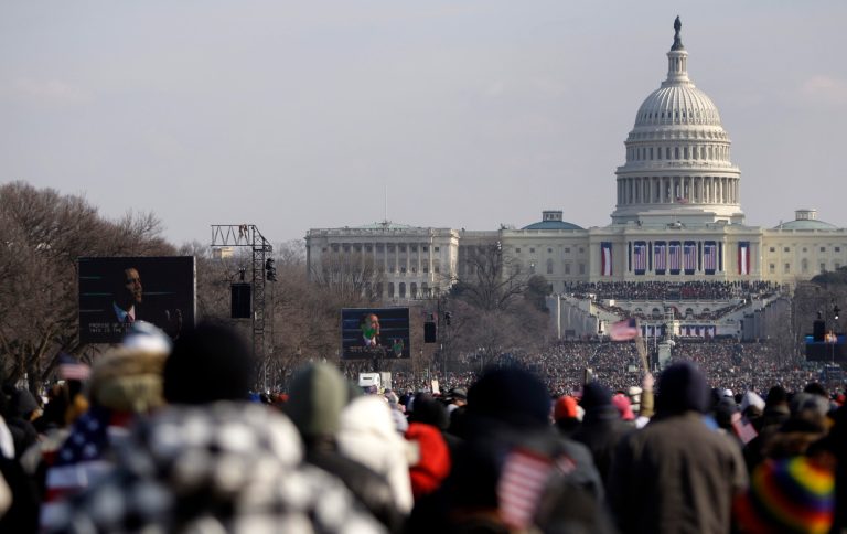 President Barack Obama is seen on the screen as he delivers his inaugural address over a packed National Mall in Washington, Tuesday, Jan. 20, 2009. (AP Photo/Carolyn Kaster)