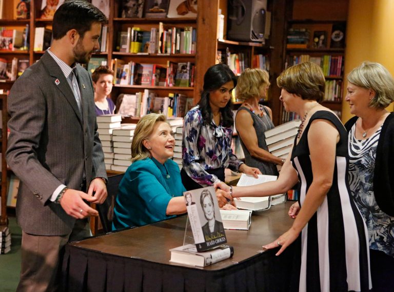 Former Secretary of State Hillary Rodham Clinton greets fans as she signs copies of her new book 