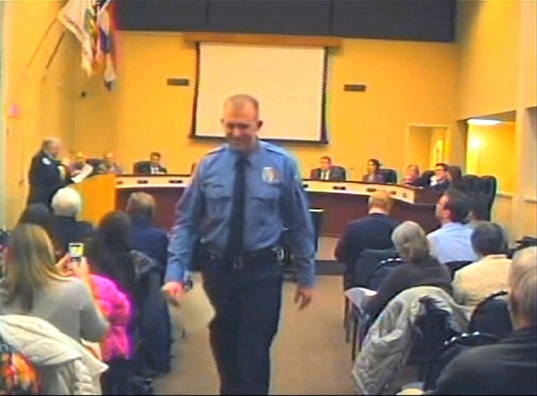 Officer Darren Wilson attends a city council meeting in Ferguson. Police identified Wilson, 28, as the police officer who shot 18-year-old Michael Brown on Aug. 9, 2014 in Ferguson. Police departments across the country are bracing for large demonstrations when a grand jury decides whether to indict Wilson. (AP Photo/City of Ferguson, File)