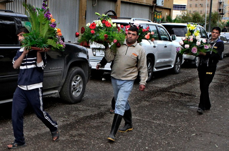   Iraqi people deliver flowers to the hospital where Iraqi President Jalal Talabani is receiving treatment at the Medical City in Baghdad, Iraq, Wednesday, Dec. 19, 2012. Talabani's doctors have not formally said that the 79-year-old statesman suffered a stroke, though several other government officials have confirmed that is the case. Foreign medical experts began arriving in Baghdad on Wednesday to assist Iraqi doctors treating ailing President Jalal Talabani, who remains in a Baghdad intensive care unit after suffering a stroke. (AP Photo/ Karim Kadim)  