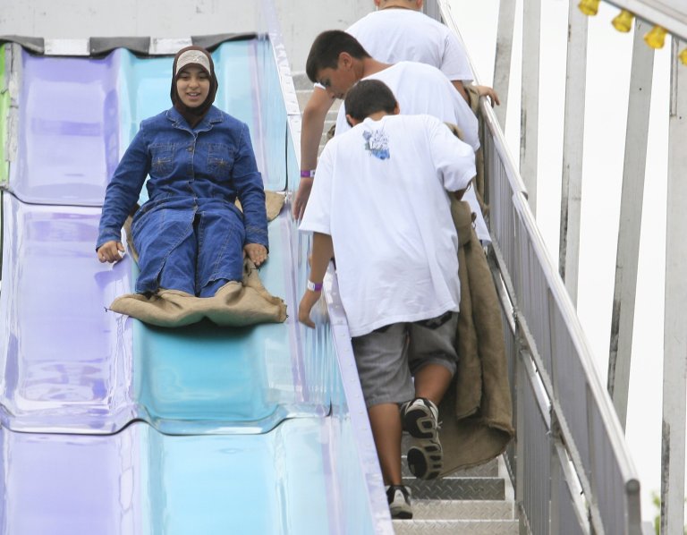   Festival goers enjoy the giant slide during the Arab International Festival, Sunday, June 17, 2012 in Dearborn, Mich. The festival opened Friday and ends Sunday in Dearborn, a community with large Arab-American and Muslim populations. About 300,000 people in southeastern Michigan have roots in the Arab world. (AP Photo/Detroit Free Press, Mandi Wright)  