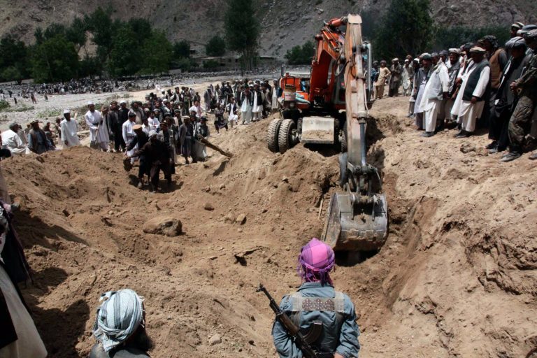   A crane is used to search for victims of Monday's earthquake in Baghlan, north of Kabul, Afghanistan on Tuesday, June 12, 2012. Scores of people are feared entombed under tons of rock and stone that buried a village in a landslide after two earthquakes in northern Afghanistan, authorities said Tuesday. A single bulldozer worked to uncover the bodies of those killed in Monday's landslide after the earthquakes struck the Hindu Kush region, but villagers fear there will be no survivors. (AP Photo/Jawed Dehsabzi)  