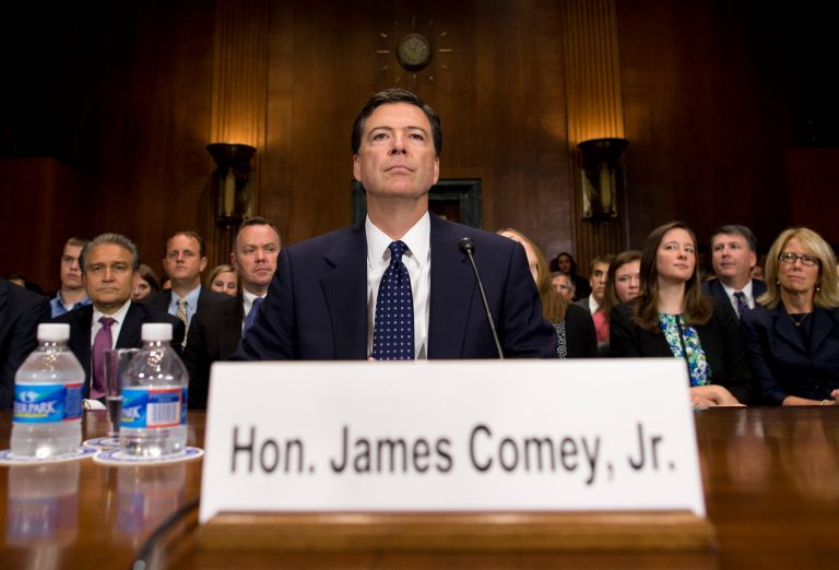 FBI Director nominee James Comey prepares to testify on Capitol Hill in Washington, Tuesday, July 9, 2013, before the Senate Judiciary Committee hearing on his nomination. Comey spent 15 years as a federal prosecutor before serving in the George W. Bush administration, where he is best known for facing down the White House over a warrantless surveillance program. (AP Photo/Evan Vucci)