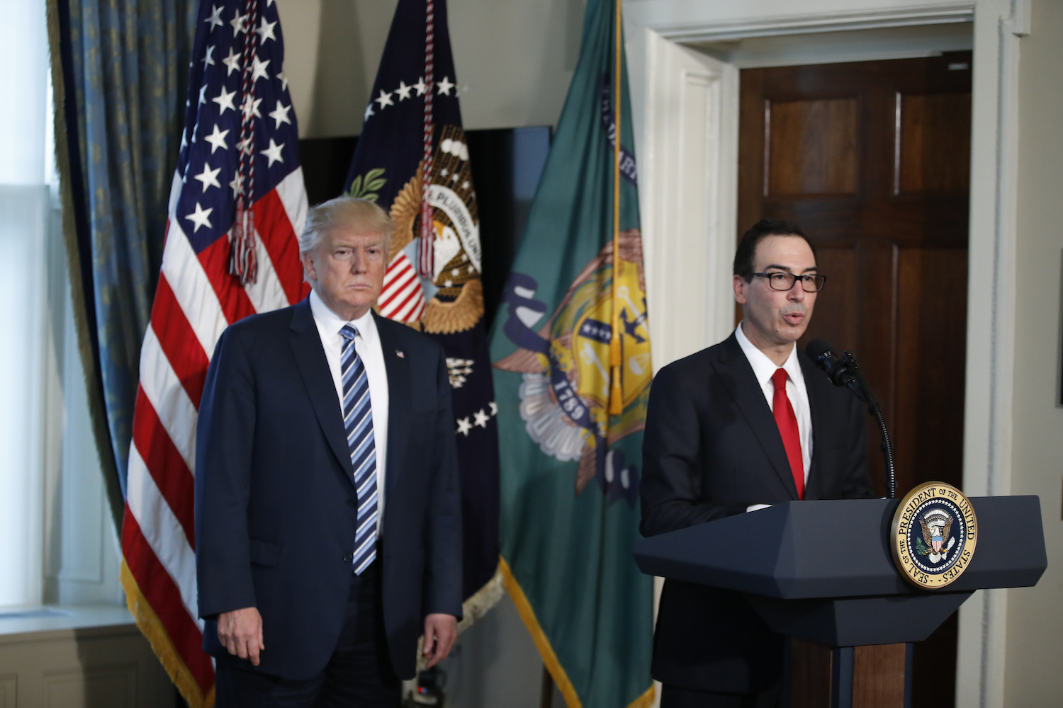 Trump signs orders aimed at simplifying tax rules, reviewing Dodd-Frank