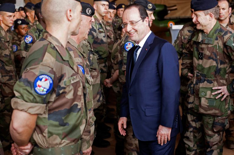 French president Francois Hollande, center, greets French troops as he arrives at the French military operation headquarters at M'Poko airport in Bangui, Central African Republic, Friday, Feb. 28, 2014. It is Hollande's second trip to Bangui since the beginning of Operation Sangaris in December. Thousands of international troops dispatched to volatile Central African Republic are there to help keep the country from breaking apart, France's president said Friday, days after the French parliament voted to prolong the country's mission in its former colony wracked by violence between Christians and Muslims. (AP Photo/Frederic  Lafargue)
