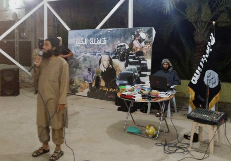 In this Friday, July 11, 2014 photo, an Islamic militant speaks to people during a celebration of their declaration of an Islamic state at a mosque in Fallujah, 40 miles (65 kilometers) west of Baghdad, Iraq. Sunni militants seized control of the Anbar city of Fallujah, and parts of Ramadi in January. The government has since reasserted its control of Ramadi, but Fallujah remains in insurgent hands. (AP Photo)