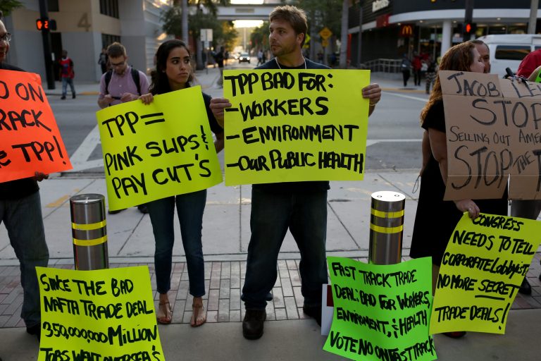MIAMI, FL - MARCH 20: Union members and community activists protest outside Miami Dade College, whereÂ U.S. Secretary of the Treasury Jacob LewÂ was speaking. (Photo by Joe Raedle/Getty Images)
