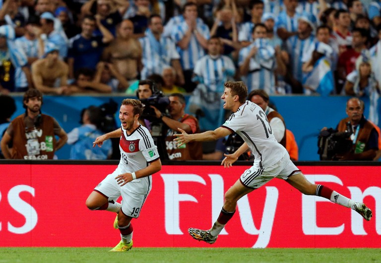 Germany's Mario Goetze, left, celebrates with Thomas Mueller after scoring the opening goal during the World Cup final soccer match between Germany and Argentina at the Maracana Stadium in Rio de Janeiro, Brazil, Sunday, July 13, 2014. Germany beat Argentina 1-0 to win its fourth World Cup title. (AP Photo/Frank Augstein)