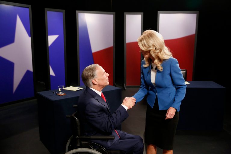 Texas State Senator Wendy Davis, right, Democratic Gubernatorial candidate, and Texas Attorney General Greg Abbott, left, Republican Gubernatorial candidate, shake hands before the final gubernatorial debate in a KERA-TV studio in Dallas on Tuesday Sept. 30, 2014. Ebola, ethics and education are among the issues that dominated the final debate between the two. (AP Photo/The Dallas Morning News, Andy Jacobsohn, Pool)