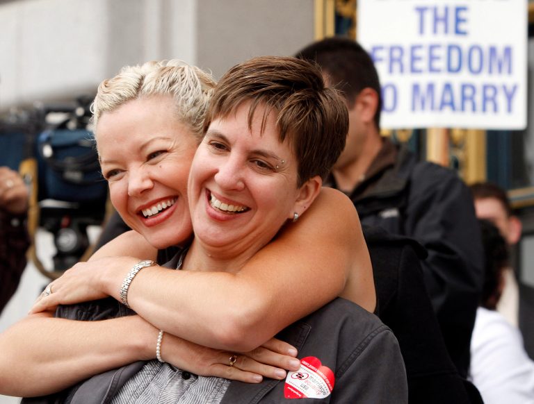   In this file photo from Aug. 12, 2010, gay couple Tara Walsh, left, and Wen Minkoff embrace outside City Hall in San Francisco. The U.S. Supreme Court decided Friday, Dec. 7, 2012, to hear the appeal of a ruling that struck down Proposition 8, the stateâs measure that banned same sex marriages. The highly anticipated decision by the court means same-sex marriages will not resume in California any time soon. The justices likely will not issue a ruling until spring of next year. A federal appeals court ruled in February that Proposition 8âs ban on same-sex marriage was unconstitutional. But the court delayed implementing the order until same-sex marriage opponents proponents could ask the U.S. Supreme Court to review the ruling. (AP Photo/Ben Margot)  