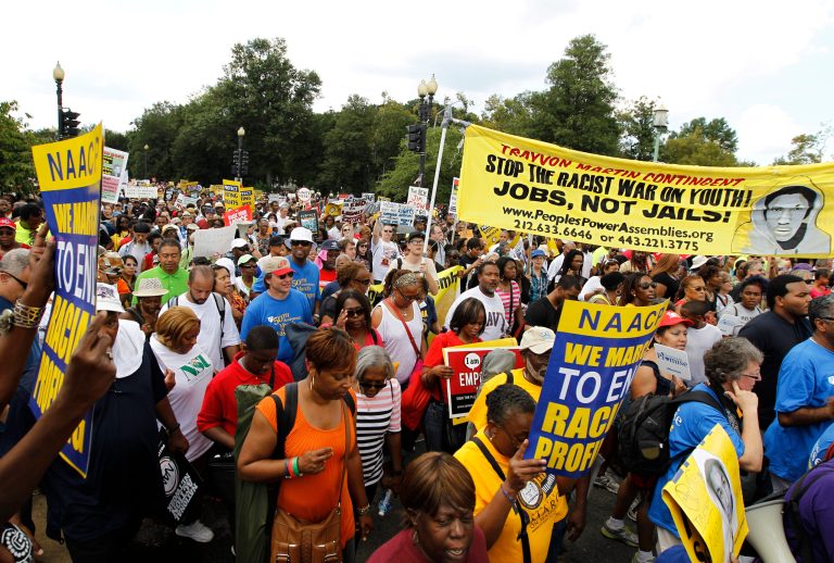   Participants march down Independence Avenue away from the Lincoln Memorial during the rally to commemorate the 50th anniversary of the 1963 March on Washington Saturday, Aug. 24, 2013, in Washington. Tens of thousands of people marched to the Martin Luther King Jr. Memorial and down the National Mall on Saturday, to commemorate King's famous 