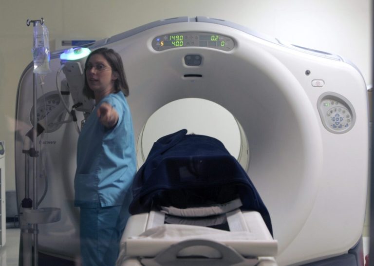 Nurse Patricia Schmidt assists with a positron emission tomography cat scan, or PET-CT, on a patient at River Radiology in Kingston, N.Y., Friday, June 15, 2007. (AP Photo/Mike Groll)
