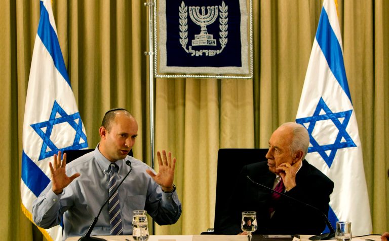 FILE - In this Thursday, Jan. 31, 2013 file photo, Israel's President Shimon Peres, right, sits with Naftali Bennett, head of Israel's Jewish Home party, during their meeting at the President's residence in Jerusalem. Israeli Prime Minister Benjamin Netanyahu reached an agreement Thursday to form a new coalition government that is expected to try to curb years of preferential treatment for the country's ultra-Orthodox minority and may push for restarting peace efforts with Palestinians. (AP Photo/Sebastian Scheiner)