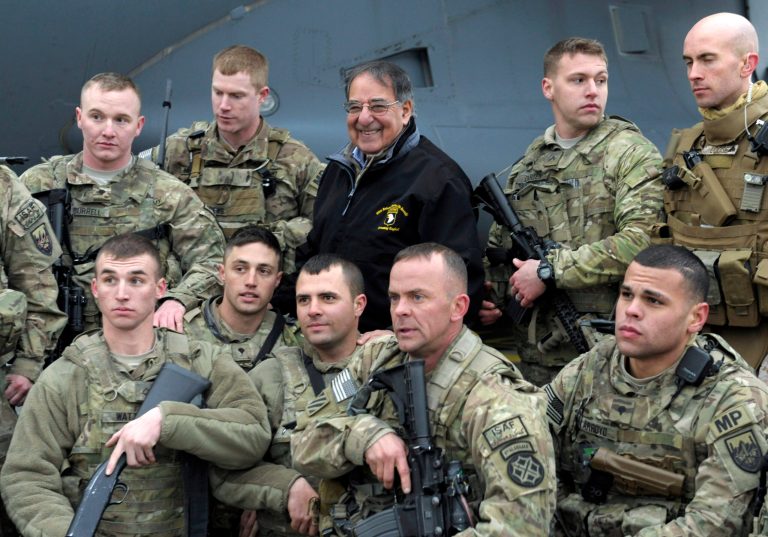   FILE - In this Dec. 14, 2012, photo, U.S. Defense Secretary Leon Panetta poses for a photo with troops at Kabul International Airport in Kabul, Afghanistan. U.S. commanders are offering glowing reviews of their 2012 Afghanistan war campaign. And the upbeat assessments that could be interpreted as leeway for President Barack Obama to order another round of troop withdrawals next summer. Panetta has not yet recommended to Obama a specific pace of withdrawals for 2013. But during the Pentagon chiefâs two-day visit to the war zone last week, commanders suggested that things are going better than is generally believed by an American public weary of war after 11 years. (AP Photo/Susan Walsh, Pool)  