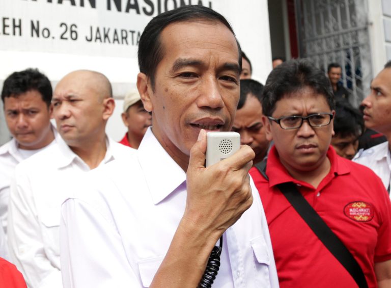 In this Sunday, March 16, 2014 photo, Indonesian presidential candidate Joko Widodo talks to his supporters during a campaign rally in Jakarta, Indonesia. Jakarta Gov. Joko Widodo, known affectionately as Jokowi, has attracted legions of supporters, especially among the young, igniting the same type of hunger for change that galvanized many previously apathetic American voters to turn out for Barack Obama in 2008. The soft-spoken former furniture producer wears simple button-down shirts with no tie or jacket and has developed a reputation of getting up close and personal with the capitalâs poor, from wading into floodwaters to visiting slums. (AP Photo/Achmad Ibrahim)