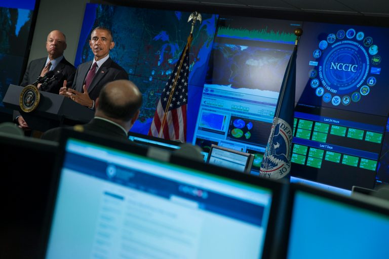 Homeland Security Secretary Jeh Johnson listens at left as President Barack Obama speaks at the National Cybersecurity and Communications Integration Center in Arlington, Va. One of the federal government's special incompetencies is protecting sensitive data. (AP Photo/Evan Vucci)