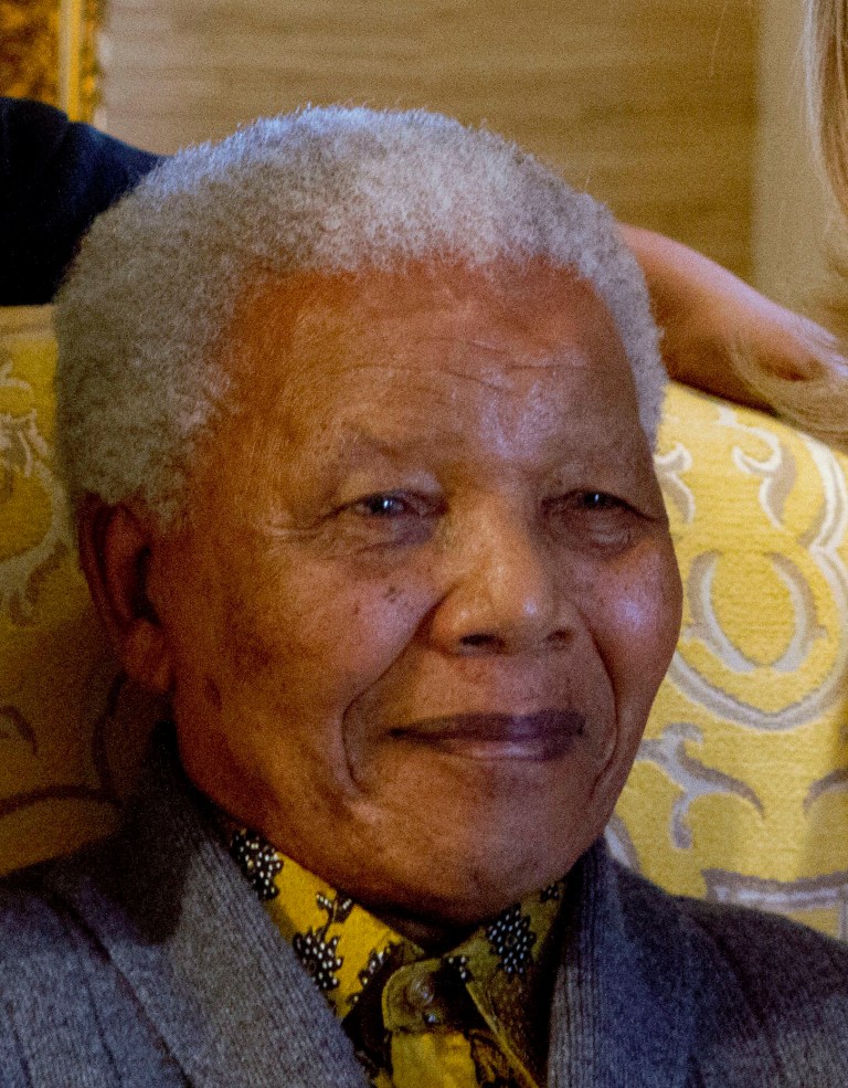   FILE - This photo taken Monday Aug. 6, 2012 shows former South African president, Nelson Mandela, when he met with US Secretary of State Hillary Rodham Clinton, unseen, at his home in Qunu, South Africa. Mandela on Friday Dec 14 2012 entered the seventh day of a hospital stay for a lung infection as questions grow about where he is receiving treatment. The 94-year-old patriarch of South Africa's democracy has been hospitalized since Saturday, first undergoing tests and later being diagnosed with the ailment. (AP Photo/Jacquelyn Martin, Pool, File)  