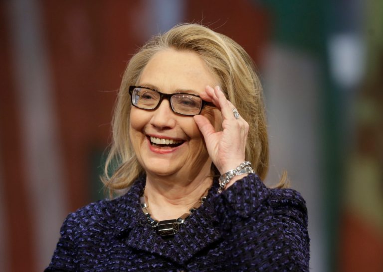 FILE - In this Jan. 29, 2013 file photo, Secretary of State Hillary Rodham Clinton adjusts her glasses during a Global Townterview at the Newseum in Washington.  Clinton says in an excerpt from her upcoming book that she wishes she could go back and revisit some of her decisions but she is 