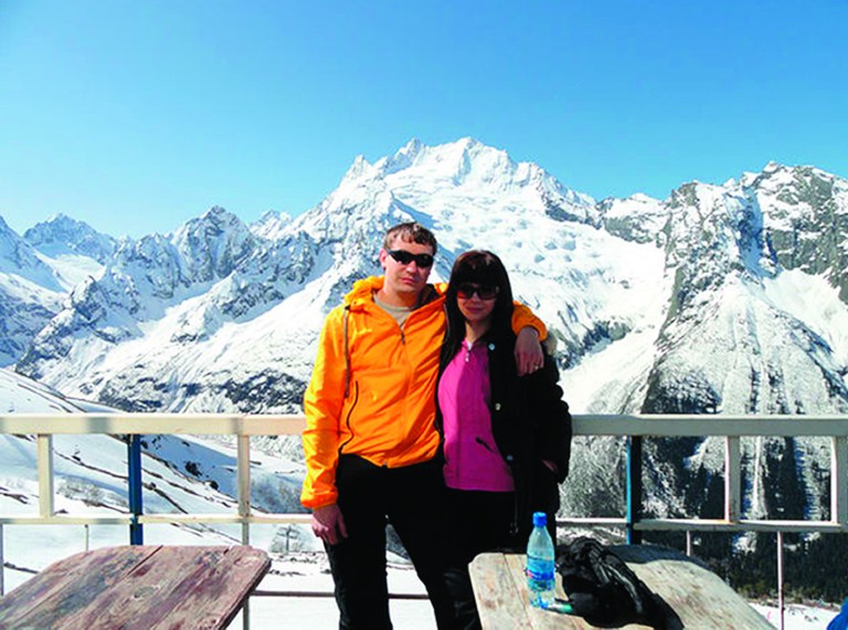 CORRECTING RESORT LOCATION TO DOMBAI - In this undated family handout photo provided Wednesday Jan. 9, 2013, by Yekaterina Achkasova and distributed by the APTN, showing Denis Burakov and his wife Yekaterina Achkasova as they pose for a picture at a winter sports venue at Dombai in the Caucasus Mountains of southern Russia. Burakov was killed and another man badly injured Thursday Jan. 3, 2013, when a thrilling ride down a ski slope inside a giant inflatable ball called a zorb, ended in tragedy when the zorb veered off course and sailed over a cliff. (AP Photo/Family photo provided by Yekaterina Achkasova, APTN)