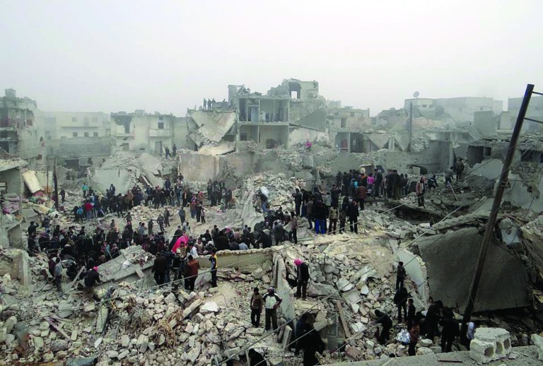 This citizen journalism image provided by Aleppo Media Center AMC, which has been authenticated based on its contents and other AP reporting, shows people searching through the debris of destroyed buildings in the aftermath of a strike by Syrian government forces, in the neighborhood of Jabal Bedro, Aleppo, Syria, Tuesday Feb. 19, 2013. The U.N. Commission of Inquiry on Syria released a 131-page report Monday, Feb. 18, 2013, detailing deepening radicalization by both sides and says fighters on both sides in Syria's civil war have committed atrocities and should be brought to justice. (AP Photo/Aleppo Media Center AMC)