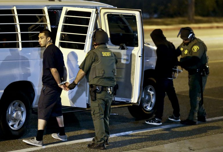 Law enforcement authorities arrested 17 individuals outside of Donald Trump's rally in Costa Mesa, Calif. (Kevin Sullivan/The Orange County Register via AP)