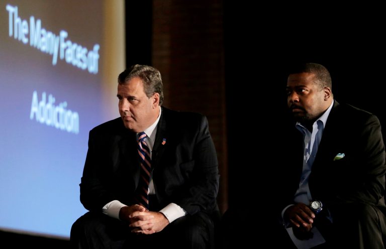 New Jersey Gov. Chris Christie, left, and New Hope Baptist Church pastor Joe Carter listen to former drug addicts talk during a summit talking about drug addiction, Tuesday, Sept. 30, 2014, in Newark, N.J. The summit, called 